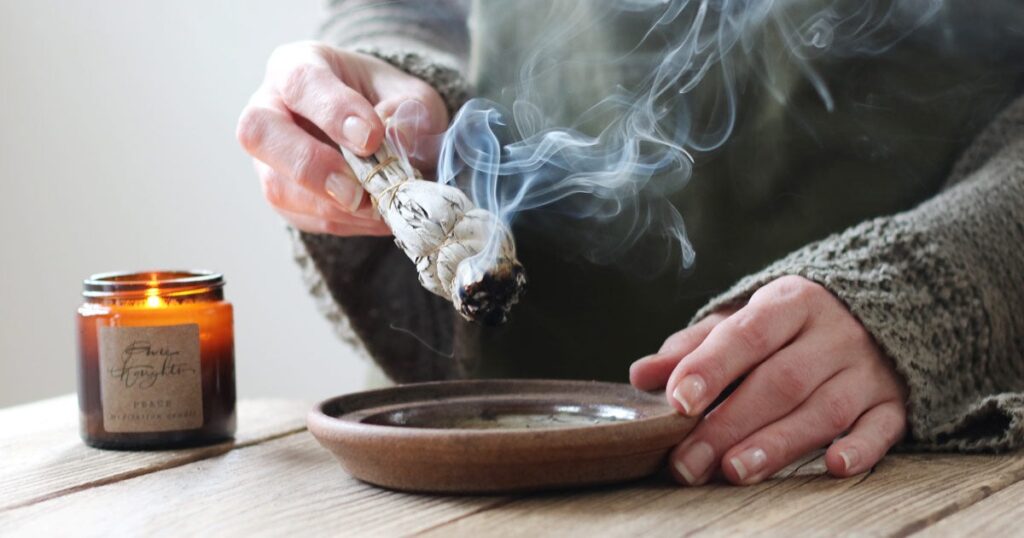 Smudging a living space with white sage to remove negative energy from your home